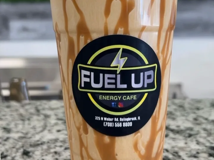 Caramel Machiatto protein coffee with caramel drizzle and a Fuel Up Energy Cafe sticker on the granite counter in Bolingbrook, IL