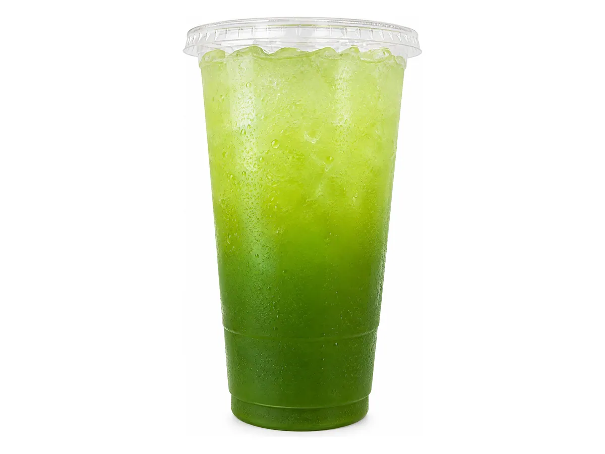 Greens Booster wellness refresher with a green ombre over ice