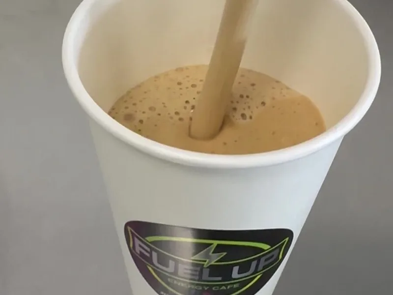Protein coffee being poured into a Fuel Up cup at Fuel Up Energy Cafe in Bolingbrook, IL
