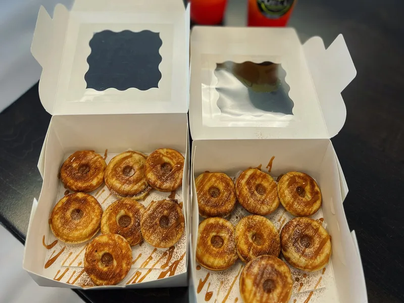 Two open boxes of mini protein donuts with caramel drizzle at Fuel Up Energy Cafe in Bolingbrook, IL